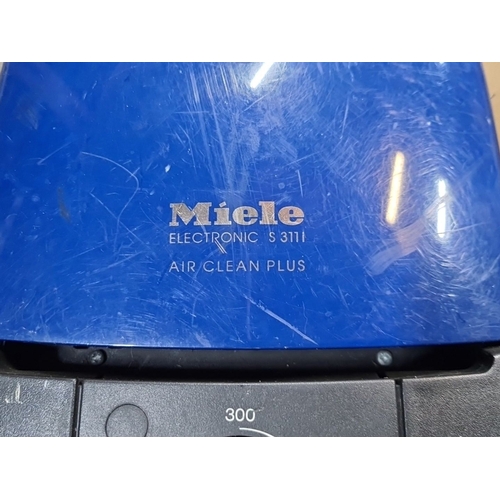 1082 - Miele Electronic S 311i vacuum cleaner, Air Clean Plus model, features a sleek blue design and robus... 