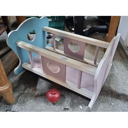 1090 - A Wooden doll cradle, pastel-colored with heart-shaped cutouts. Handmade, contemporary design.