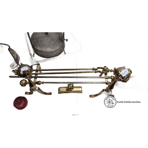 1091 - A victorian Brass fireplace tool set with ornate handles includes three tools and fire dogs.