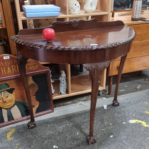 1252 - Mahogany demi-lune table with carved detailing, cabriole legs, and claw feet. From the early 20th ce... 