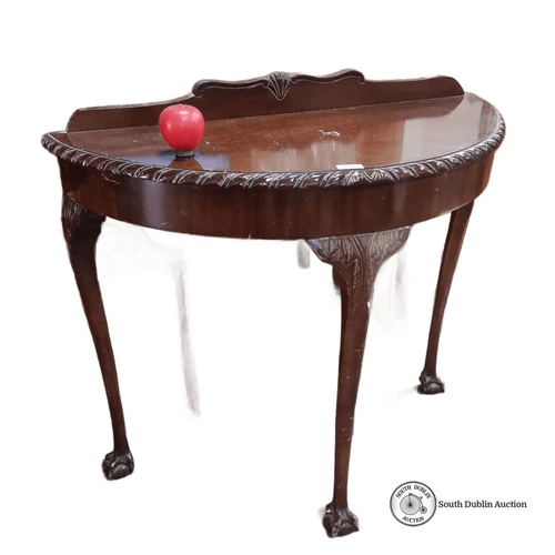 1252 - Mahogany demi-lune table with carved detailing, cabriole legs, and claw feet. From the early 20th ce... 