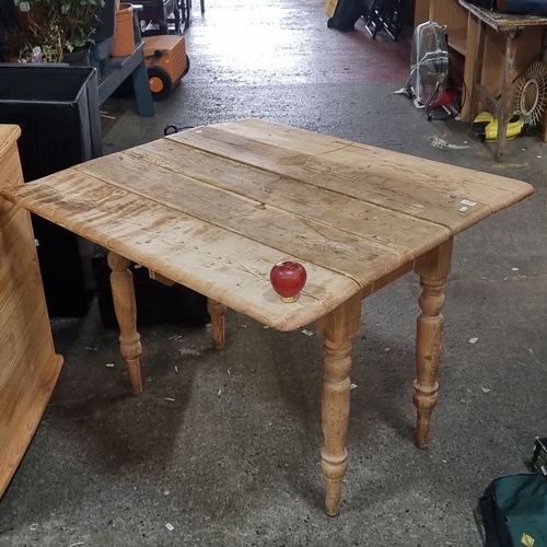 1257 - Antique pine drop-leaf table, featuring turned legs, from the 19th century.