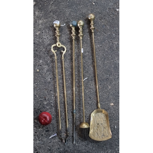 1259 - Set of four antique heavy brass fireplace tools with ornate detailing on the shovel.