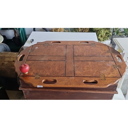 1286 - An antique wooden butler's tray with cut-out handles, showcasing burl wood veneer and hinged foldabl... 