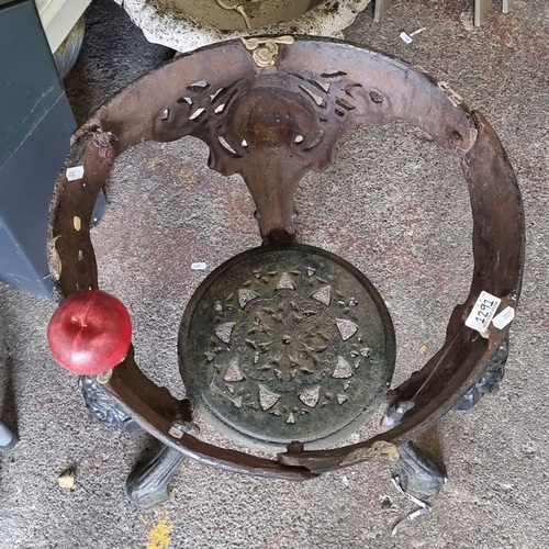 1291 - Victorian cast iron table base with ornate design, featuring stylized faces and delicate detailing.