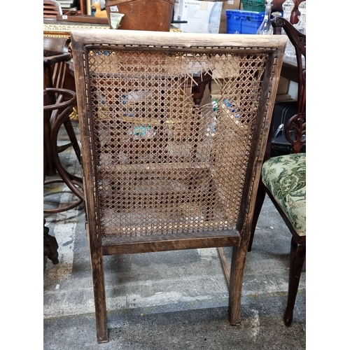 960 - Antique caned armchair with carved wood detailing, from the late 19th to early 20th century. Feature... 