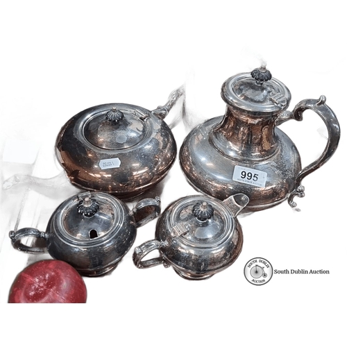 995 - Four-piece Victorian silver-plated tea set with ornate handles and finials. Includes teapot, coffee ... 