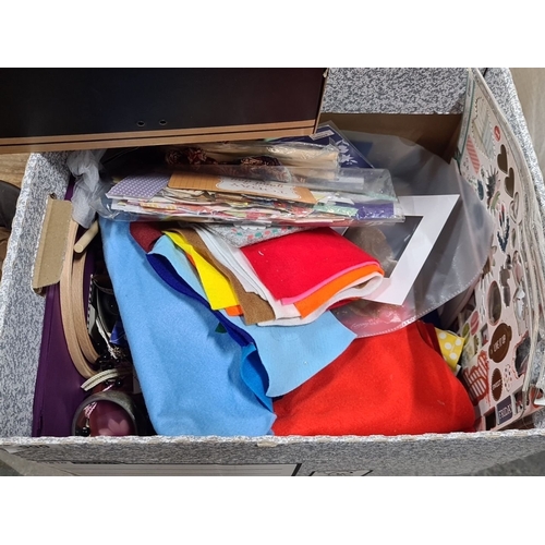 999 - Mixed craft box containing assorted fabrics, papers, feathers, and decorative items. Includes a Conv... 