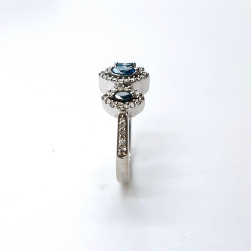 1354 - An outstanding 18 carat white gold marquis shaped blue and white brilliant cut diamond triple cluste... 