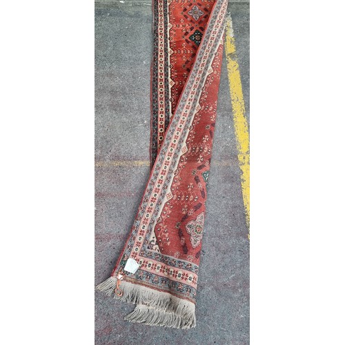 942 - Star lot : A lovely hand Knotted, hand made runner / rug  in red featuring a repetitve pattern with ... 