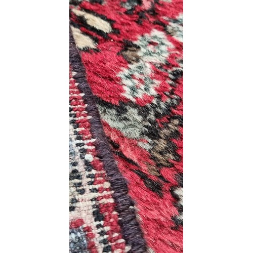 945 - Star Lot : A super hand knotted Persian runner / rug with red ground with floral design in red, beig... 