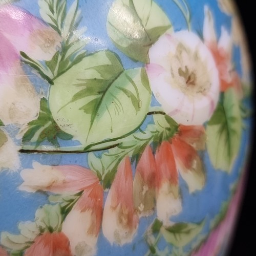 320 - A Napoleon III hand painted opaline vase. Features delicates flowers and gilt detailing.