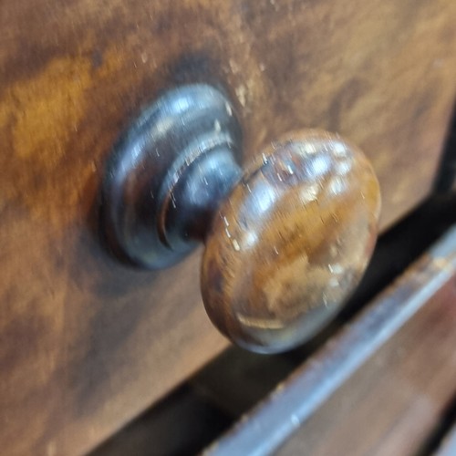 811 - An antique chest of drawers with five drawers with turned wood handles, missing two.