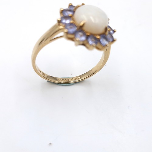 4 - Star Lot : A very pretty nine carat gold hallmarked opal central stone ring with amethyst petals.  S... 