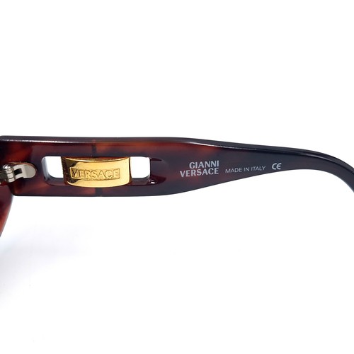 19 - A pair of Versace sunglasses set in faux tortoise shell frames. Made in Italy. Serial nos. stamped t... 