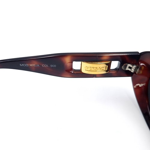 19 - A pair of Versace sunglasses set in faux tortoise shell frames. Made in Italy. Serial nos. stamped t... 