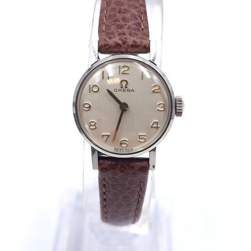 20 - Star lot : A nice example of an Omega  wristwatch set with Arabic dial together with original Omega ... 