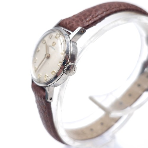 20 - Star lot : A nice example of an Omega  wristwatch set with Arabic dial together with original Omega ... 