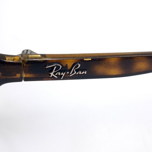 23 - A pair of Ray-Ban wrap round sunglasses set with faux tortoise shell frames with marked serial nos. ... 