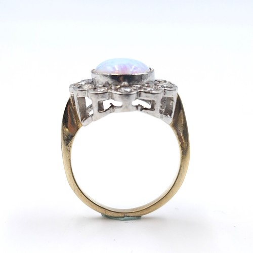 24 - A silver gilt fire opal stone ring with gem set surround. Ring size - Q 1/2. Weight - 5.45 grams.