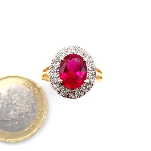 29 - Star Lot : A fabulous example of a central ruby stone ring with diamond cluster mount set in silver ... 