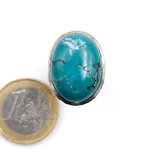 31 - A fabulous heavy turquoise stone ring mounted in sterling silver. Ring size - N. Weight - 10.55 gram... 