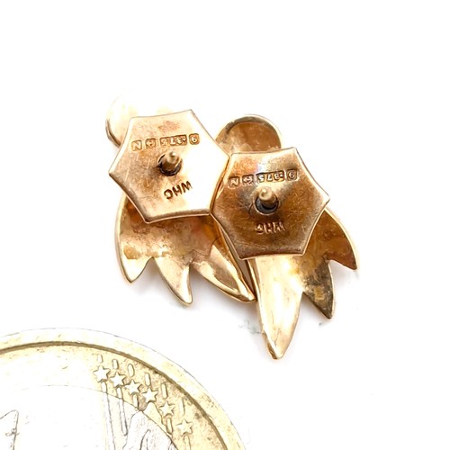 38 - A pair of nine carat gold pearl stud earrings with leaf design mount. Total weight - 1.8 grams. Boxe... 