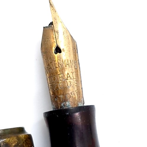 55 - Two mottled body fountain pens. The first a Waterman's example with nib (Damaged). Together with a p... 