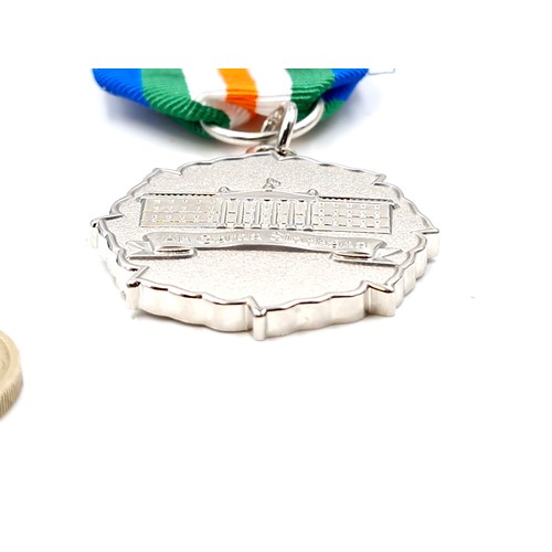 76 - An Irish 1916 commemorative medal and ribbon.