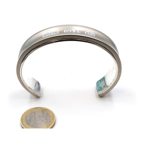 129 - Star Lot : A heavy  Tiffany & Co. bangle bracelet stamped '1997 Tiffany & Co. 925'. Total weight - 6... 