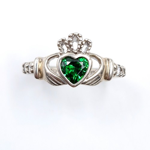 137 - A sterling silver green gemstone claddagh ring inscribed 'Love, Loyalty & Friends'. Size - M. Weight... 