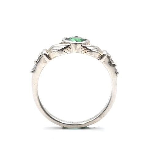 137 - A sterling silver green gemstone claddagh ring inscribed 'Love, Loyalty & Friends'. Size - M. Weight... 