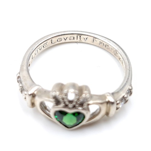 137 - A sterling silver green gemstone claddagh ring inscribed 'Love, Loyalty & Friends'. Size - M. Weight... 