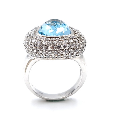 143 - A designer sterling silver aquamarine and cubic zirconia cluster ring. Size - N. Weight - 9.9 grams.