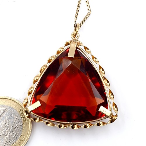 165 - Star Lot : A heavy nine carat gold cushion cut topaz on a nine carat gold chain. Total weight - 21 g... 