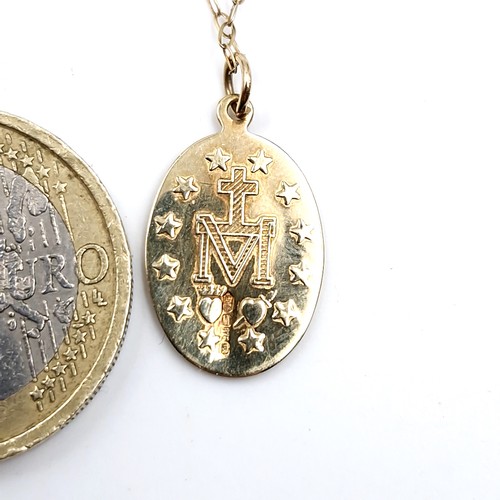 192 - A nine carat gold miraculous medal with nine carat gold chain. Length - 44 cms. Weight - 1.58 grams.