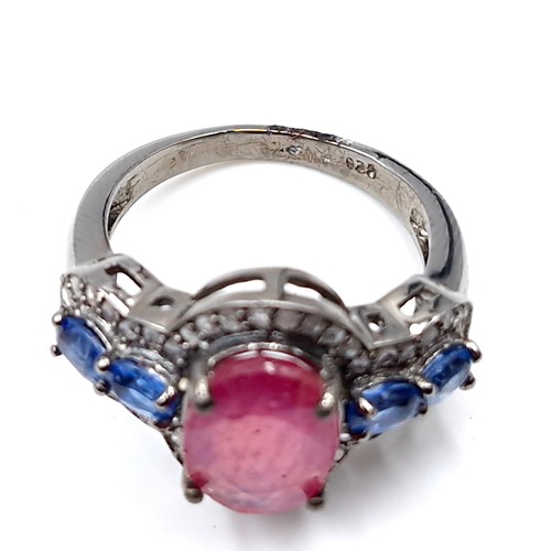 559 - Star lot : A most unusual 3.35ct ruby ring with .80ct kyanite stones and .40ct diamond, set in sterl... 