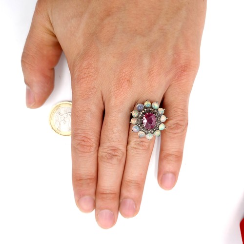 561 - Star Lot : A very attractive 3.7ct ruby set ring with .20ct diamond and 2.90cts opal surround mounte... 