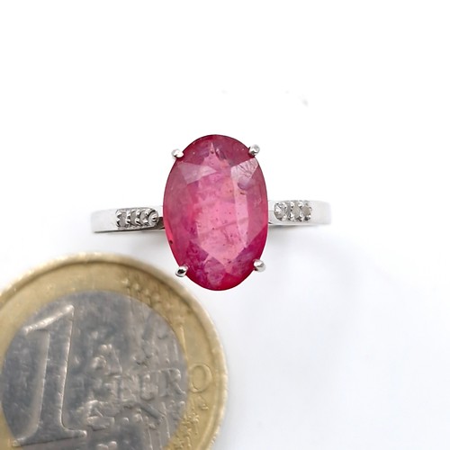 580 - A fabulous 3ct oval cut ruby gemstone ring with .10ct diamond shoulders set in sterling silver stamp... 