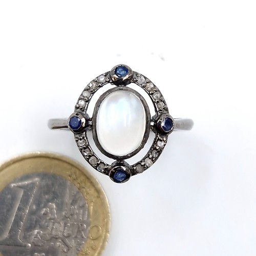 583 - An unusual 2.10cts moonstone ring with approx. .20cts diamonds and approx. .40cts sapphires set in s... 