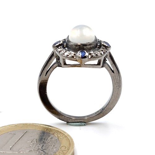 583 - An unusual 2.10cts moonstone ring with approx. .20cts diamonds and approx. .40cts sapphires set in s... 