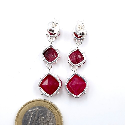 592 - A pair of ruby drop earrings graduating in size set in sterling silver with backs suitable for pierc... 