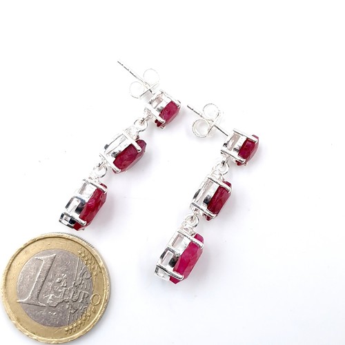 592 - A pair of ruby drop earrings graduating in size set in sterling silver with backs suitable for pierc... 