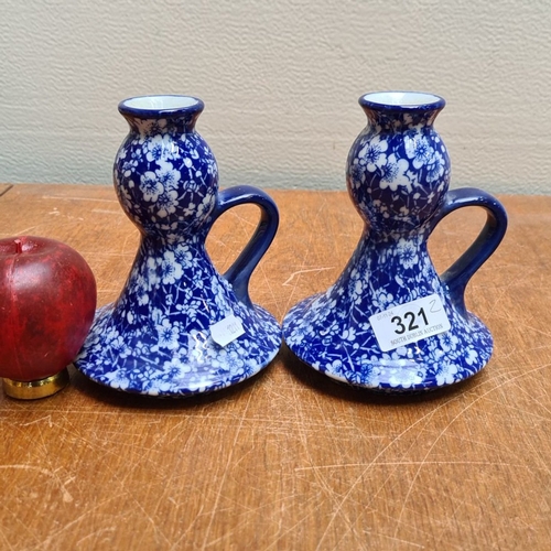 321 - Pair of blue and white floral ceramic candle holders, marked on the base.