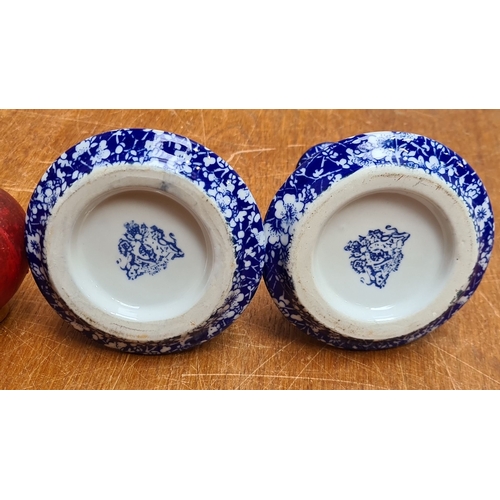 321 - Pair of blue and white floral ceramic candle holders, marked on the base.