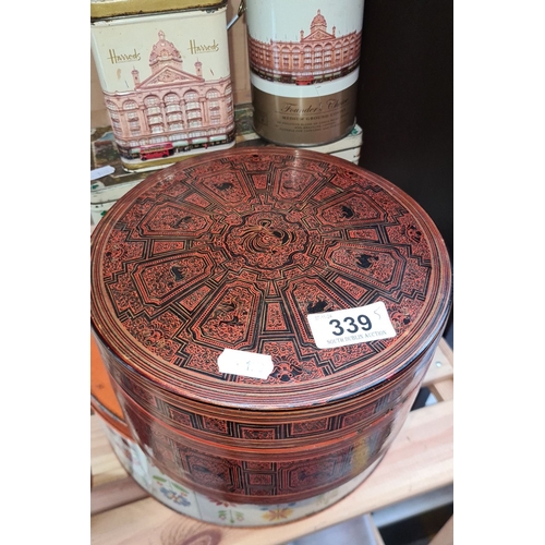 339 - Collection of vintage decorative tins, including Harrods branding and intricately patterned designs.... 