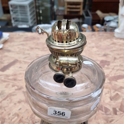 356 - Victorian-era oil lamp with ornate brass base and glass reservoir, featuring 