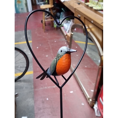 361 - Metal garden stake featuring a colorful Robin redbreast  perched within a heart-shaped frame.