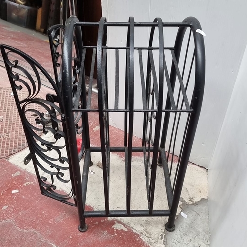 364 - Black wrought iron wine rack with ornate scrollwork, featuring a curved top and double doors.