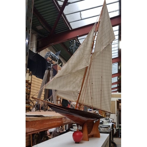 393 - Star lot : A very large Wooden model sailboat with white sails. Base included for display. About 4'6... 